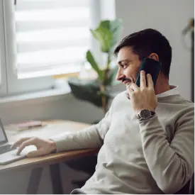 Man sitting at his desk talking on the phone