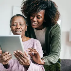 Senior in assisted home holding digital tablet