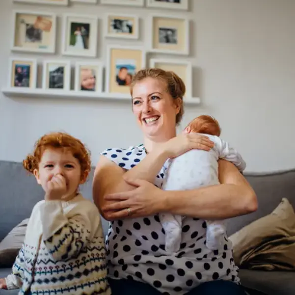 Happy mum with toddler and baby