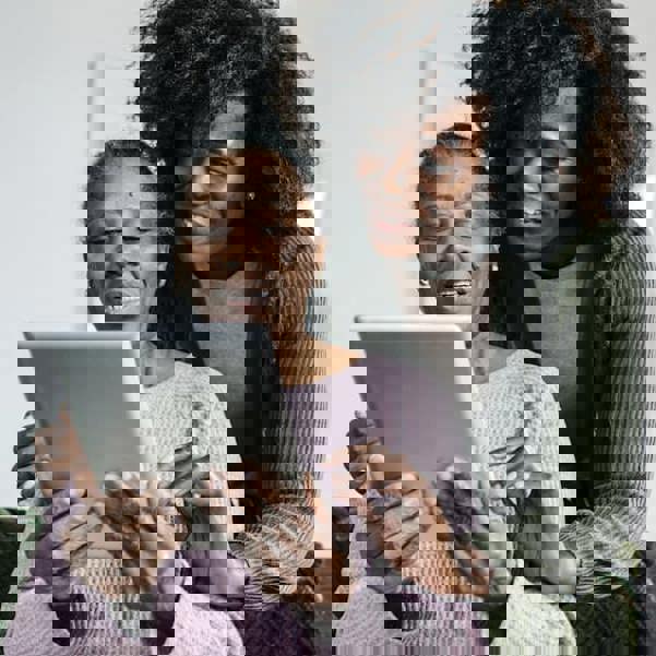 Senior in assisted home holding a digital ipad